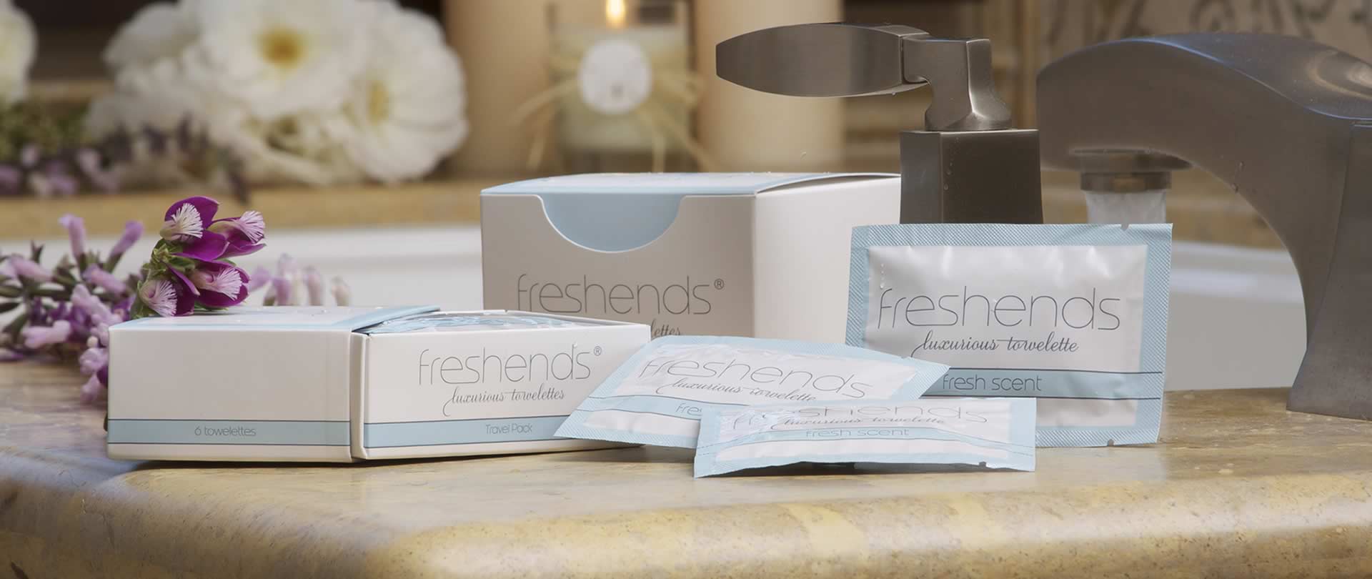 Freshends packaging on a bathroom counter with flowers and a faucet in the background